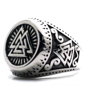Valknut Norse signet ring stainless steel three-quarter left view with carved sunburst design and engraved knotwork