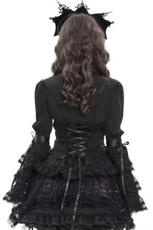 Gothic lace-up corset back detail with layered ruffles, rear view on model with long curly hair