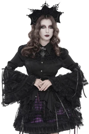 Black Victorian lace corset blouse with ruffled bell sleeves, front three-quarter view on model wearing gothic crown