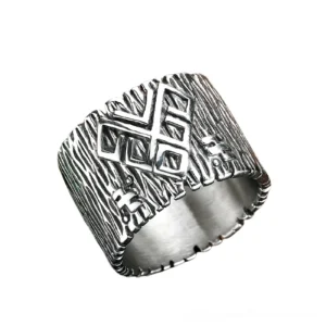 Ancient Viking rune talisman ring in stainless steel, side oblique view showing embossed Nordic runes with wood grain texture pattern