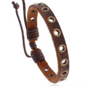 Vintage brown leather gothic bracelet with distressed texture and silver metal grommets, close-up side view showing adjustable lace-up cord detail