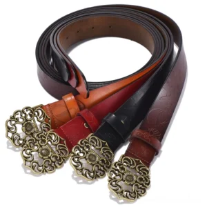 Four color variations of vintage leather gothic belts displaying black, coffee brown, red, and orange with matching geometric buckles, flat lay view