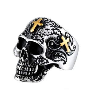 Vintage gothic skull ring with gold cross accents and floral engravings, silver-tone metal finish, three-quarter front view
