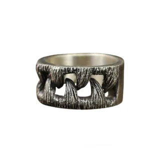Vintage stainless steel monster teeth gothic ring front view, silver-black brushed finish, flat lay on white background showing prominent teeth decoration and wide band design
