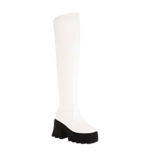 White gothic over-the-knee platform boots with decorative fretwork heel and square toe, studio shot