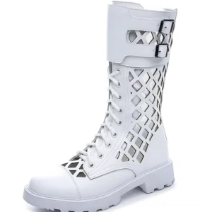 White leather gothic platform combat pumps with adjustable buckle straps, cutout details, and thick lug sole studio view