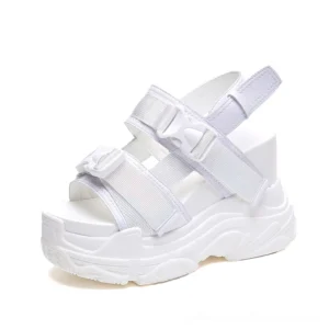 White gothic platform sandals with double buckle fasteners and thick platform sole, shot from right angle showing open-toe construction