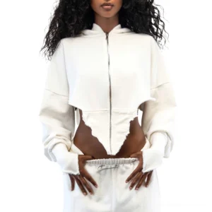 White cropped zip-up gothic hoodie with exposed midriff and finger holes, front studio view