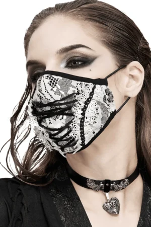 White lace gothic face mask with black corset lace-up front, worn by model in left profile showing detailed lace work and dark makeup