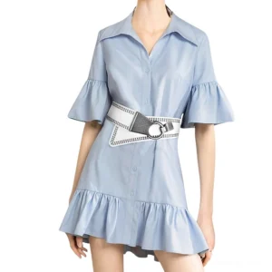 White wide studded belt with silver metal buckle worn by female model, studio photoshoot front view showcasing fit and styling