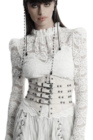 White underbust corset with adjustable studded buckle straps on fashion model, detailed hardware view