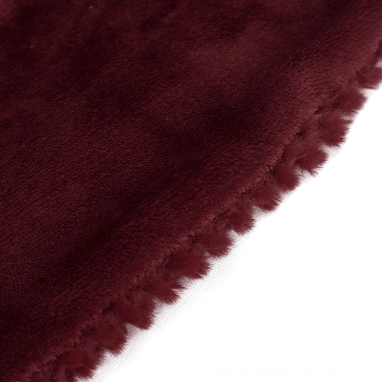 Close-up texture shot of burgundy faux fur material used in gothic choker collar, showing short dense pile