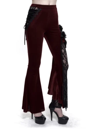 Front view of wine red gothic flared pants with black lace-up side accents on model