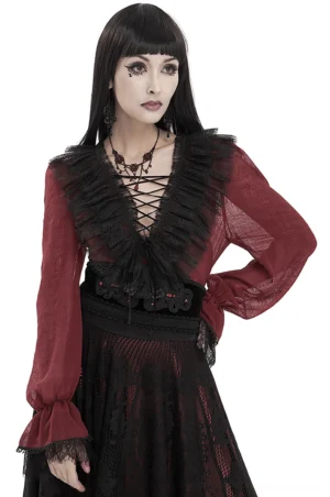 Wine red gothic ruffle blouse with black lace V-neckline and front lace-up detail, worn by model in front three-quarter view showing sheer burgundy fabric and ruffled cuffs