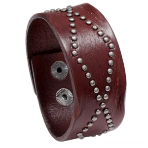 Wine red leather gothic cuff bracelet featuring geometric rivet detailing and secure snap fastener, studio shot on white background