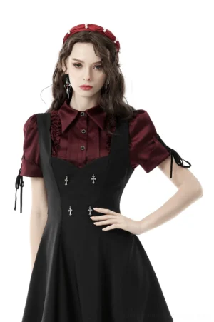 Wine red gothic puff sleeve blouse styled with black pinafore dress, front three-quarter view on fashion model