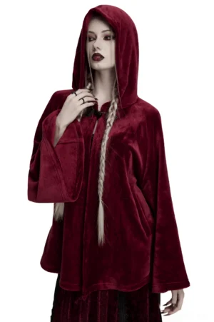 Wine red velvet hooded moon cape worn by goth woman with long braid, front view showcasing heart-shaped toggle closures and loose silhouette