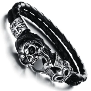 Close-up top view of winged skull charm with black cubic zirconia stones on stainless steel, gothic bracelet detail shot