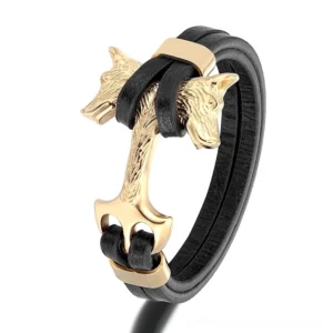 Gold-tone dual wolf head gothic leather bracelet with stainless steel clasp, front oblique view on white background