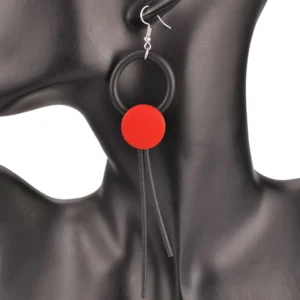 Red wooden round drop earrings with dual rubber tassels and silver aluminum hardware, displayed on black mannequin for gothic jewelry styling inspiration