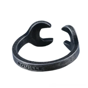 Industrial wrench open ring with distressed black finish, left oblique view showcasing the mechanical design and engraved rouille text on vintage stainless steel
