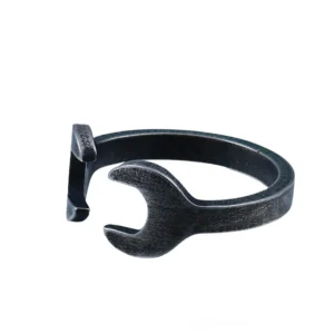 Wrench-shaped statement ring in matte black, front center view displaying the open wrench head design and industrial aesthetic perfect for gothic and alternative fashion