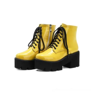 Yellow gothic platform ankle boots with round toe, lace-up closure, and side zipper, featuring chunky square heel and shiny patent finish