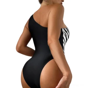 One-shoulder gothic swimsuit back view showing zebra print panel and high-cut leg silhouette